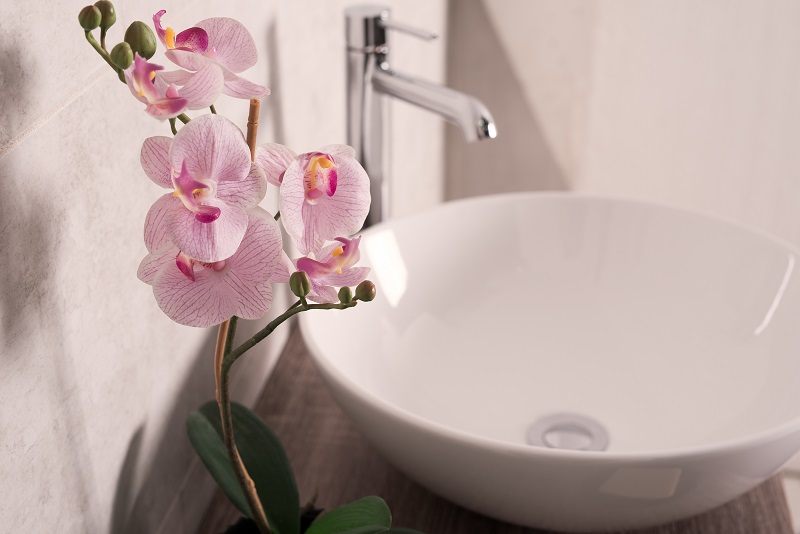 soft-focus-of-orchids-flower-beside-a-sink-in-a-bathroom.jpg