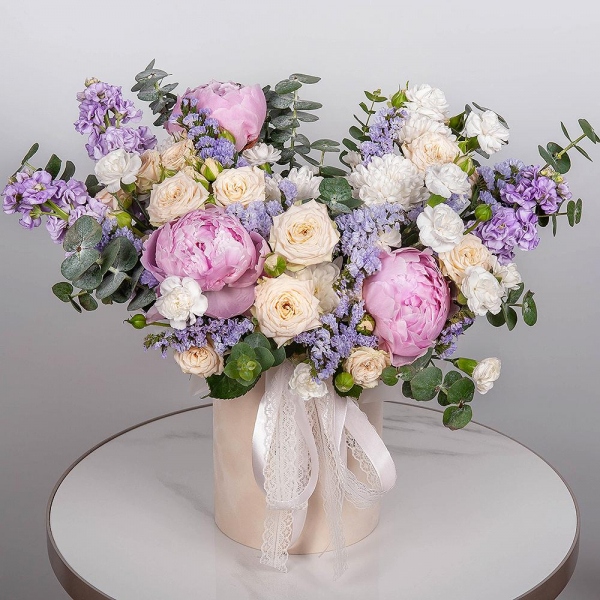 Peony pink - 3, Peony sprayrose - 2, Baltica White Spray Chrysanthemum - 2, White spray carnation - 9, Matthiola Lilac - 5, Round flower box small , Oasis, Blue Statice, Eucalyptus, Ribbon