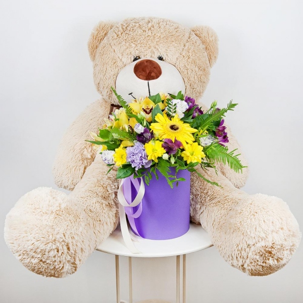 Gerbera yellow - 3, Lilac carnation - 3, Orchid bud yellow/brown Cymbidium - 3, Alstromeria Yellow, Orange - 2, Bacardi Yellow Spray Chrysanthemum - 3, Alstromeria lilac, purple - 2, Purple Lisianthus (Eustoma) - 7, Round flower box small , Film, Oasis, Pistachio, Ruscus, Ambrella, Flask for orchids, Ribbon, Teddy bear 90 cm