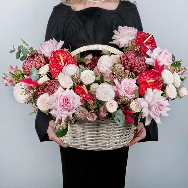 Red cut anthurium - 4, Chrysanthemum Bigoudi purple - 4, Peony style roses - 7, Ranunculus Pink - 5, Alstromeria white, soft pink - 11, Peony sprayrose - 5, Medium Basket, Oasis, Waxflower (1 pc.), Eucalyptus, Dried flowers in assortment