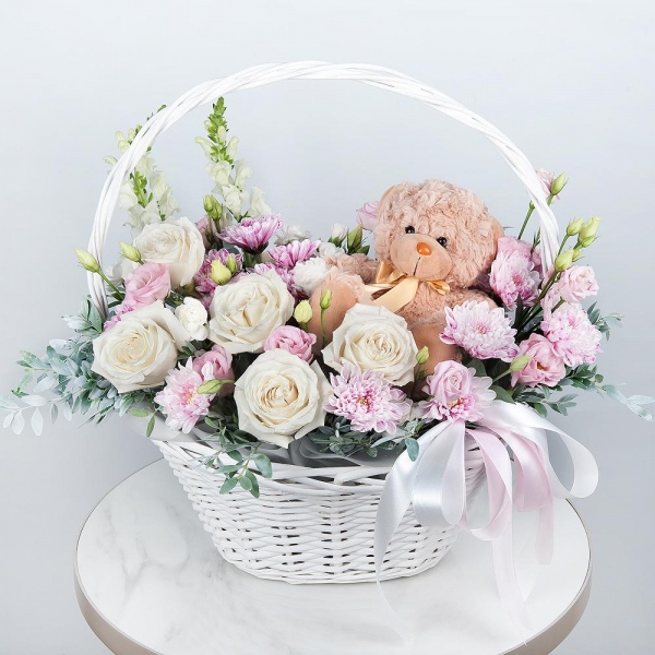 White Matthiola - 2, White rose 50 cm - 7, Baltica Pink Spray Chrysanthemum - 3, White spray carnation - 3, Pink Lisianthus (Eustoma) - 2, Medium Basket, Oasis, Pistachio, Teddy bear 20 cm, Ribbon
