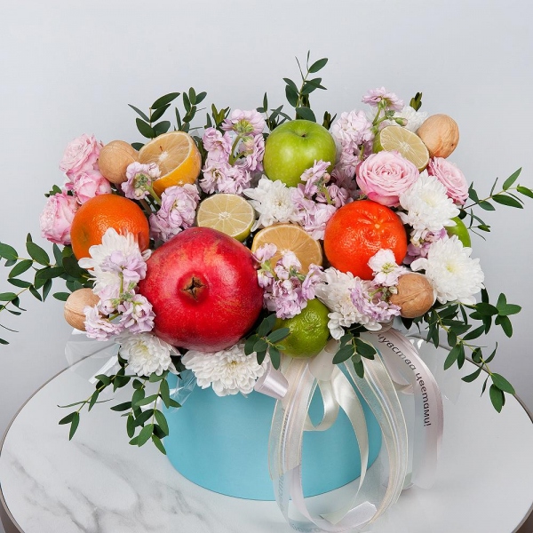 Baltica White Spray Chrysanthemum - 2, Matthiola Lilac - 7, Peony sprayrose - 2, Round flower box medium, Oasis, Eucalyptus, Apple, 1 pc., Lemon, 1 pc., Tangerine, 1 pc., Walnut (10 pieces), Pomegranate, Wooden skewer, Wrapping Paper