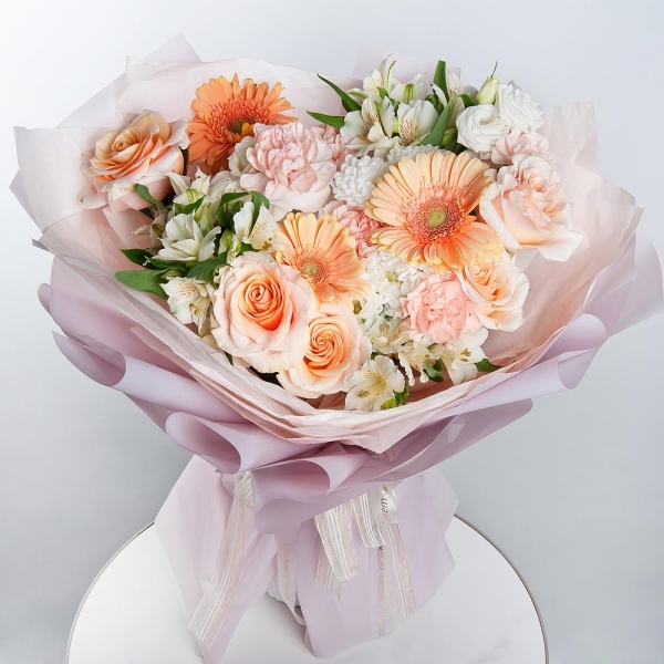 Cream gerbera - 3, Baltica White Spray Chrysanthemum - 2, Carnation white, cream - 11, Pink-orange rose Phoenix 50 cm - 5, Alstromeria white, soft pink - 3, lisianthus - 2, Wrapping Paper