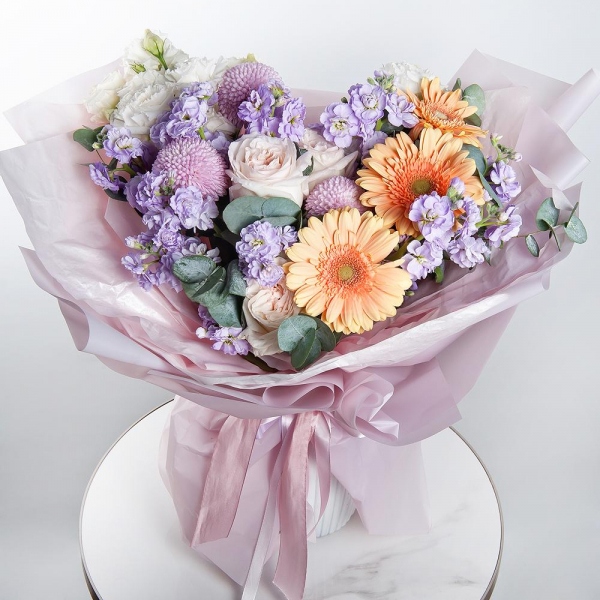 Cream gerbera - 7, Peony style roses - 3, Momoko Chrysanthemum - 3, Matthiola Lilac - 5, lisianthus - 3, Eucalyptus, Wrapping Paper