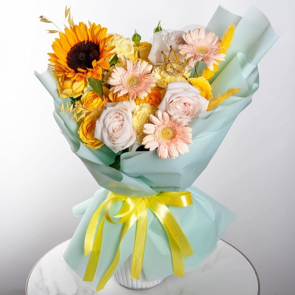 Sunflower - 1, Cream gerbera - 5, Spray rose: yellow, orange 50 cm - 3, Yellow carnation - 6, Peony style roses - 3, Dried flowers in assortment, Decorative crown, Wrapping Paper