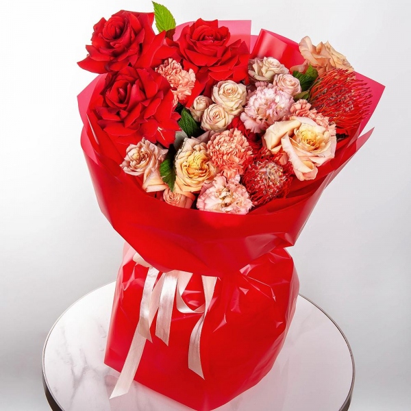 Red rose Nina 50 cm - 7, Cream Rose 50 cm Ecuador (Creme Caramel) - 4, Carnation white, cream - 5, Pink Lisianthus (Eustoma) - 2, Spray rose: white, cream, light pink 50 cm - 2,  Raspberry branch, Wrapping Paper, Nutan
