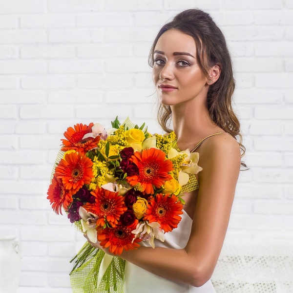 Gerbera daisies - 10, White Cymbidium Orchid Bud - 9, Spray rose: red 50 cm - 7, Yellow rose 50 cm - 7, Flask for orchids, Solidago (1 pc.), Pistachio, Mesh (Abaka), Ribbon