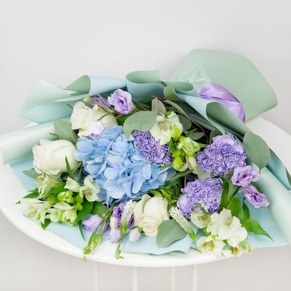 Blue/purple hydrangea - 1, Lilac carnation - 3, Alstromeria white, soft pink - 3, Purple Lisianthus (Eustoma) - 2, White rose 50 cm - 3, Veronica spray, Eucalyptus populus (1 pc.), Wrapping Paper