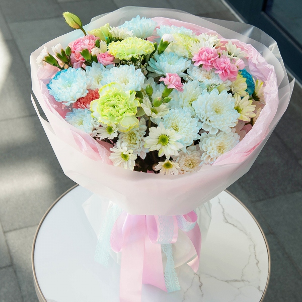 Chrysanthemum spray Baltica painted blue - 4, Pink carnation - 4, Carnation white, cream - 8, Bacardi Yellow Spray Chrysanthemum - 4, Pink spray carnation - 7, Limonium (1 pc.), Wrapping Paper
