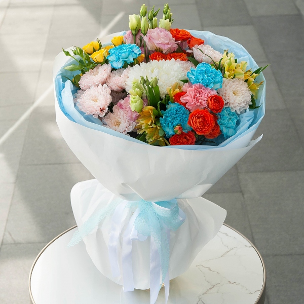 Baltica Pink Spray Chrysanthemum - 2, Magnum White Chrysanthemum - 1, Pink carnation - 3, Carnation white, cream - 7, Pink Lisianthus (Eustoma) - 2, Alstromeria Yellow, Orange - 7, Spray rose: yellow, orange 50 cm - 3, Wrapping Paper