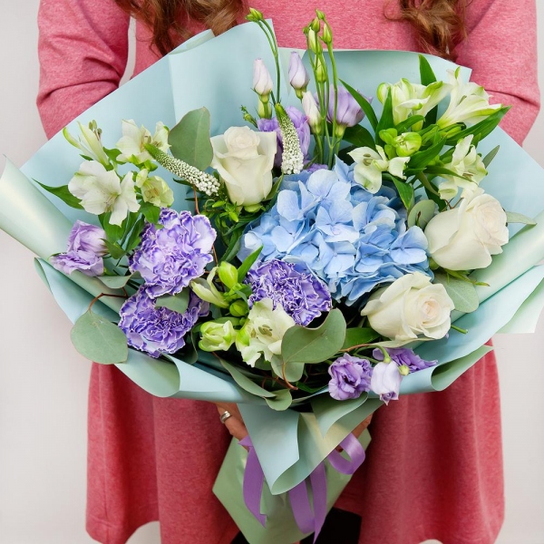 Blue/purple hydrangea - 1, Lilac carnation - 3, Alstromeria white, soft pink - 3, Purple Lisianthus (Eustoma) - 2, White rose 50 cm - 3, Veronica spray, Eucalyptus populus (1 pc.), Wrapping Paper