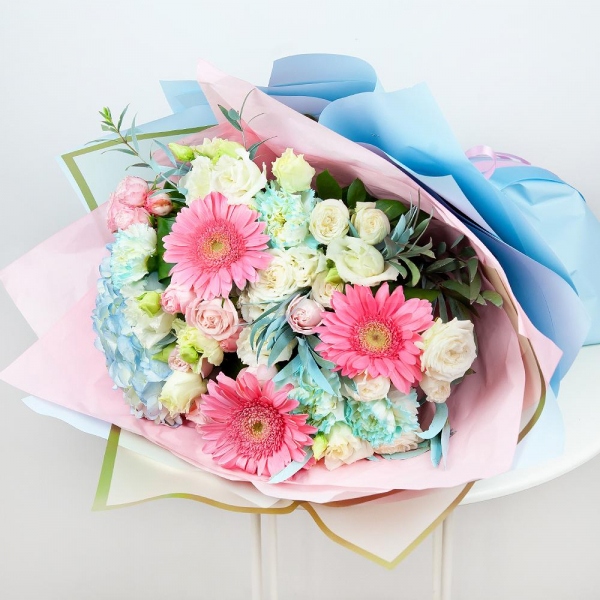 Blue/purple hydrangea - 1, Gerbera pink - 5, Blue carnation - 7, Spray rose: white, cream, light pink 50 cm - 4, lisianthus - 3, Aspidistra (1 pc.), Eucalyptus, Wrapping Paper