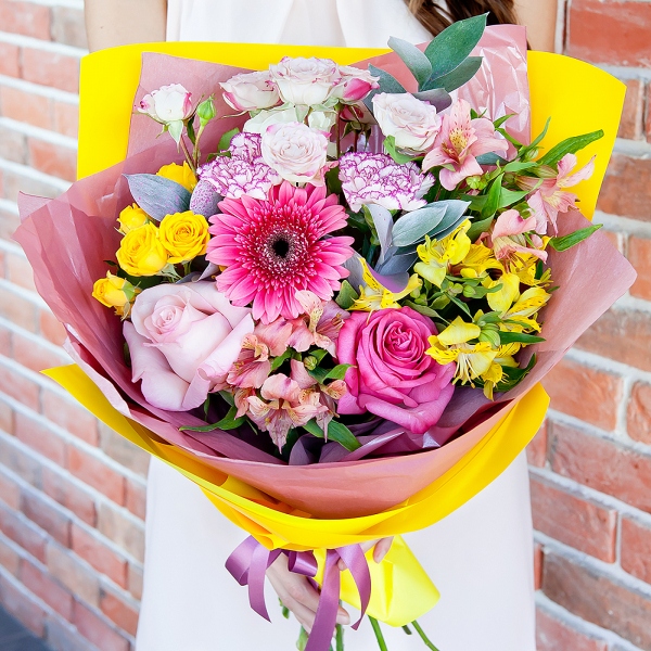 Gerbera pink - 1, Alstromeria white, soft pink - 2, Pink carnation - 2, Spray rose: yellow, orange 50 cm - 1, Pink rose 50 cm - 2, Alstromeria Yellow, Orange - 1, Spray rose: white, cream, light pink 50 cm - 1, Ruscus, Wrapping Paper