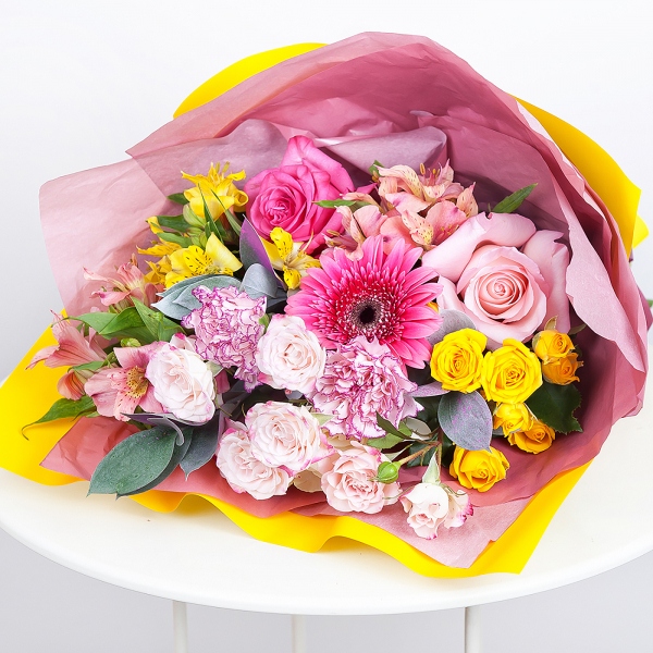 Gerbera pink - 1, Alstromeria white, soft pink - 2, Pink carnation - 2, Spray rose: yellow, orange 50 cm - 1, Pink rose 50 cm - 2, Alstromeria Yellow, Orange - 1, Spray rose: white, cream, light pink 50 cm - 1, Ruscus, Wrapping Paper