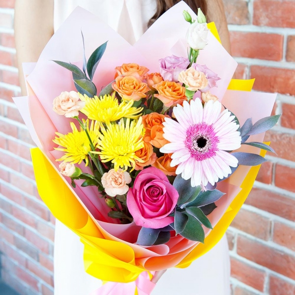 Spray rose: yellow, orange 50 cm - 3, Pink spray carnation - 3, Baltica Yellow Spray Chrysanthemum - 3, Pink Lisianthus (Eustoma) - 4, Gerbera pink - 2, Pink rose 50 cm - 3, Ruscus, Wrapping Paper