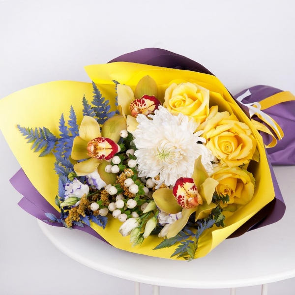 Magnum White Chrysanthemum - 1, Orchid bud yellow/brown Cymbidium - 3, Purple Lisianthus (Eustoma) - 2, Yellow rose 50 cm - 3, Flask for orchids, Hypericum, Solidago (1 pc.), Fern (1 pc.), Wrapping Paper