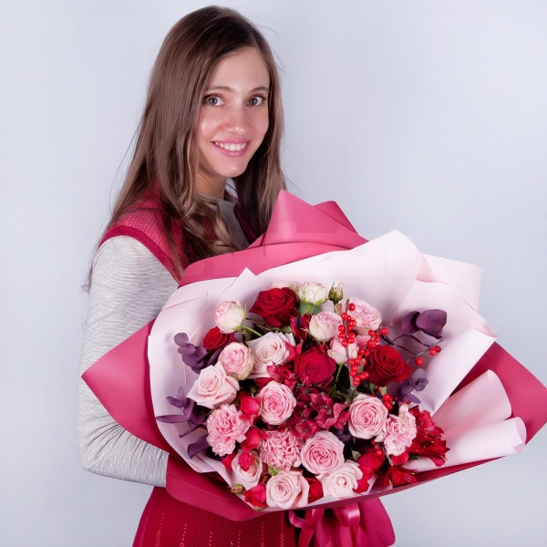 Spray rose: red 50 cm - 4, Peony sprayrose - 2, Pink carnation - 4, Alstromeria Red, Bright Pink - 2, Red rose 50 cm - 5, Pink rose 50 cm - 5, Ilex, Eucalyptus Cinerea, Wrapping Paper, Ribbon