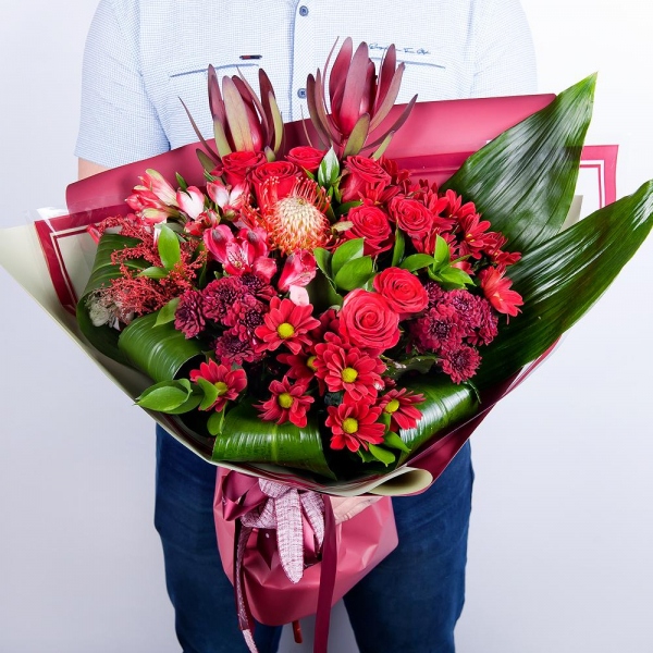 Bacardi Red Spray Chrysanthemum - 4, Red rose 50 cm - 12, Alstromeria Red, Bright Pink - 5, Daisy poms Santini pink, purple - 3, Leukodendron, Aspidistra (1 pc.), Solidago (1 pc.), Wrapping Paper, Ribbon, Ruscus, Nutan