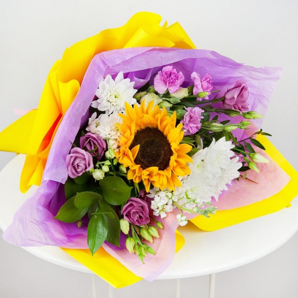 Baltica White Spray Chrysanthemum - 3, Pink Lisianthus (Eustoma) - 3, Pink spray carnation - 2, White Matthiola - 2, Sunflower - 1, Pistachio, Ruscus, Wrapping Paper