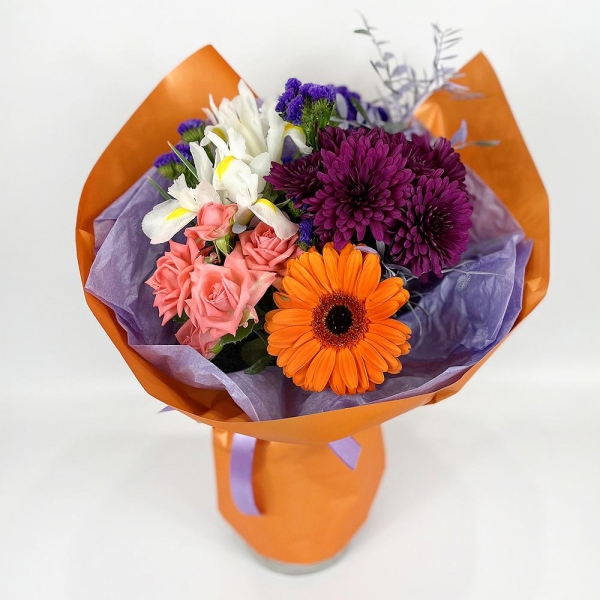 Gerbera daisies - 2, White iris - 4, Bright pink spray rose mix, 50 cm - 2, Baltica Pink Spray Chrysanthemum - 3, Blue Statice, Wrapping Paper, Pistachio