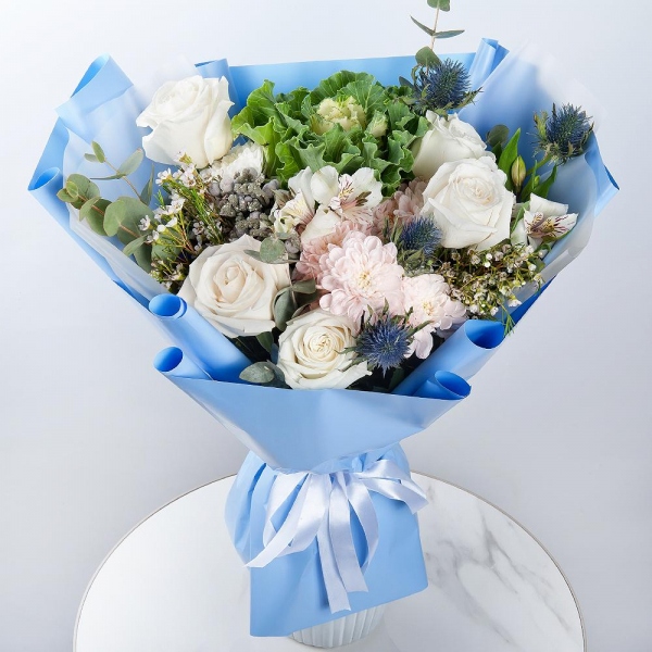 White rose 50 cm - 9, Baltica Pink Spray Chrysanthemum - 3, Alstromeria white, soft pink - 2, Brassica, Eryngium, Brunia Green Lanuginosa (1 pc.), Waxflower (1 pc.), Eucalyptus, Wrapping Paper