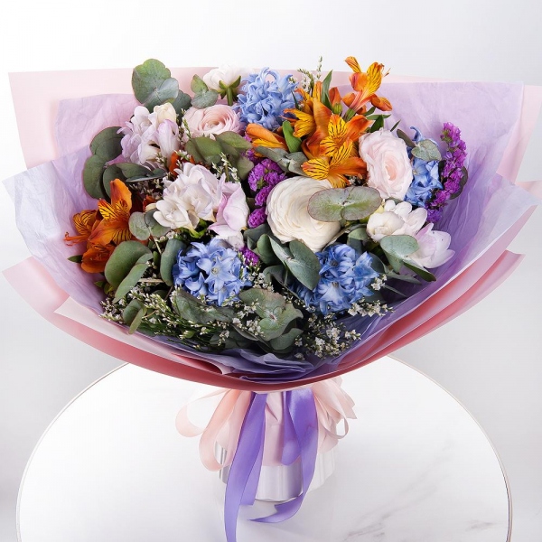 Blue Hyacinth - 5, Freesia - 3, Ranunculus Pink - 3, Alstromeria Yellow, Orange - 4, Limonium (1 pc.), Blue Statice, Eucalyptus, Wrapping Paper