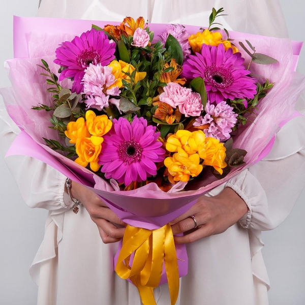 Purple gerbera - 5, Pink Hyacinth - 4, Alstromeria Yellow, Orange - 5, Pink spray carnation - 5, Freesia - 4, Pistachio, Eucalyptus, Wrapping Paper