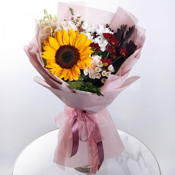 Sunflower - 1, Pink carnation - 4, Bacardi White Spray Chrysanthemum - 1, Bacardi Red Spray Chrysanthemum - 1, Astilbe, Waxflower (1 pc.), Pistachio, Salal, Wrapping Paper