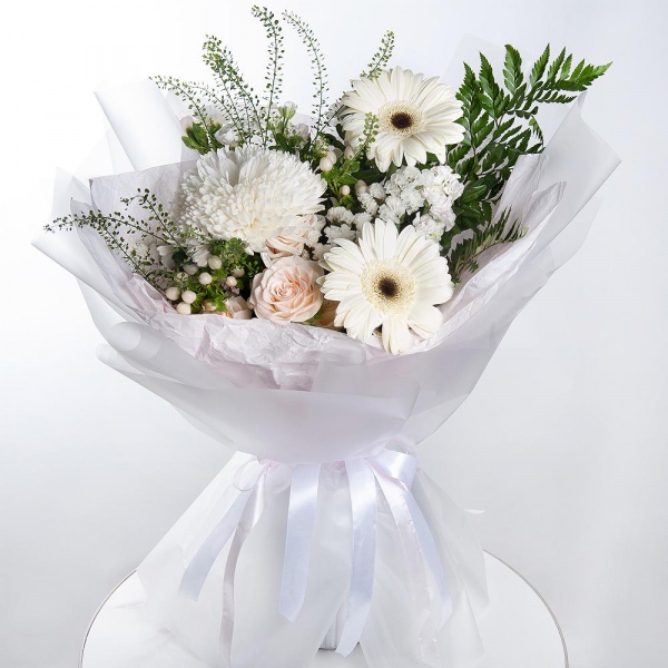Gerbera white - 4, Magnum White Chrysanthemum - 1, Peony sprayrose - 1, White spray carnation - 2, White Matthiola - 2, Hypericum, White statice, Pistachio, Fern (1 pc.), Green bell (1 pc.), Wrapping Paper